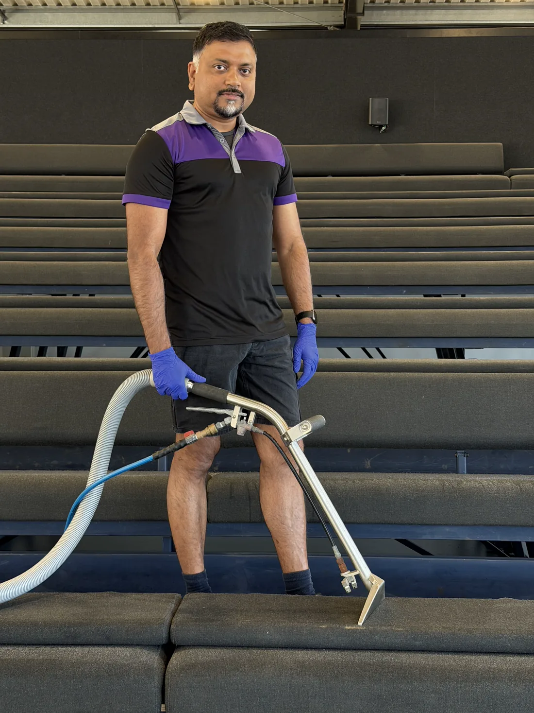 Bency, ApexClean's owner-operator, with a carpet steam-extraction wand